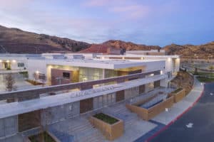 Modern transit building set into a hillside at dusk