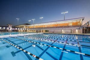Outdoor competition pool with lane markings and floodlights